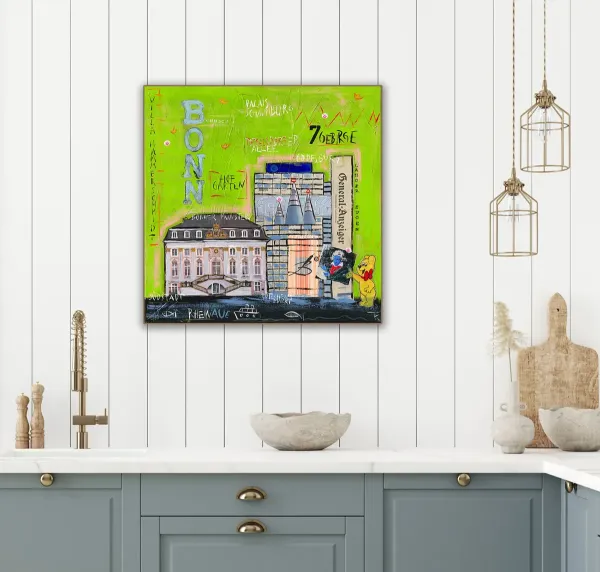 Leinwandbild Bonn-City in Grün an weißer Wand über hellblauen Küchenschränken.